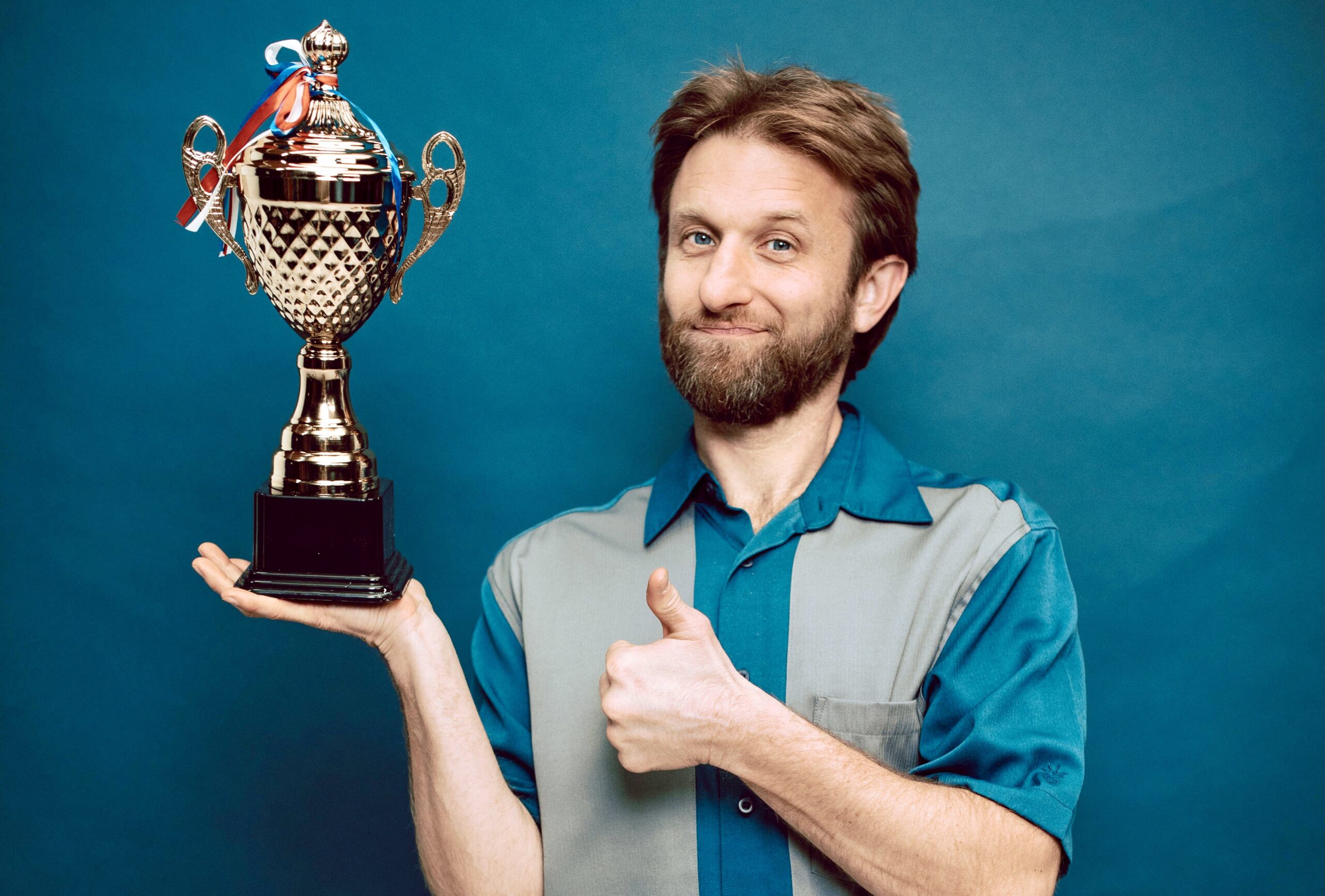 Man proudly holding a trophy.