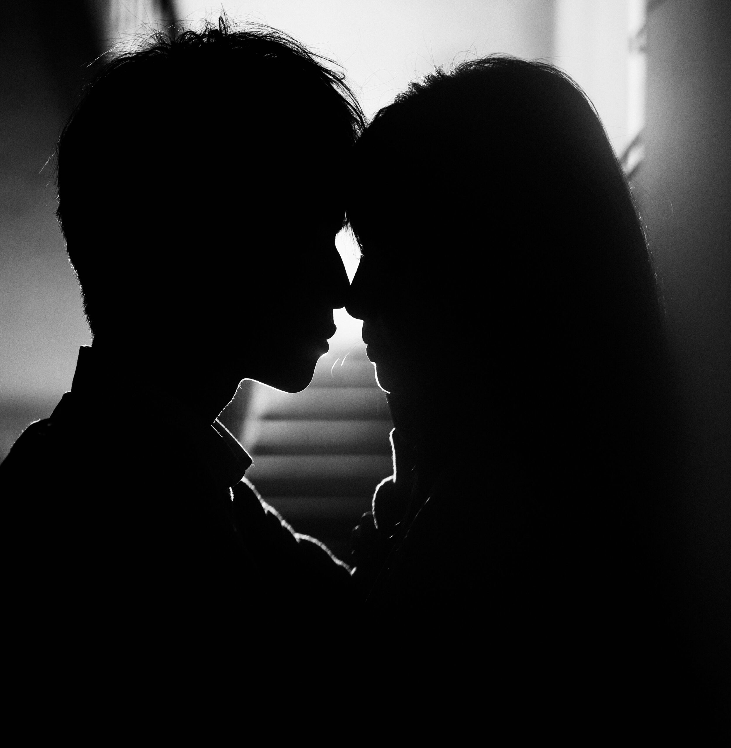 Silouhette of a man and woman close and in kissing distance.