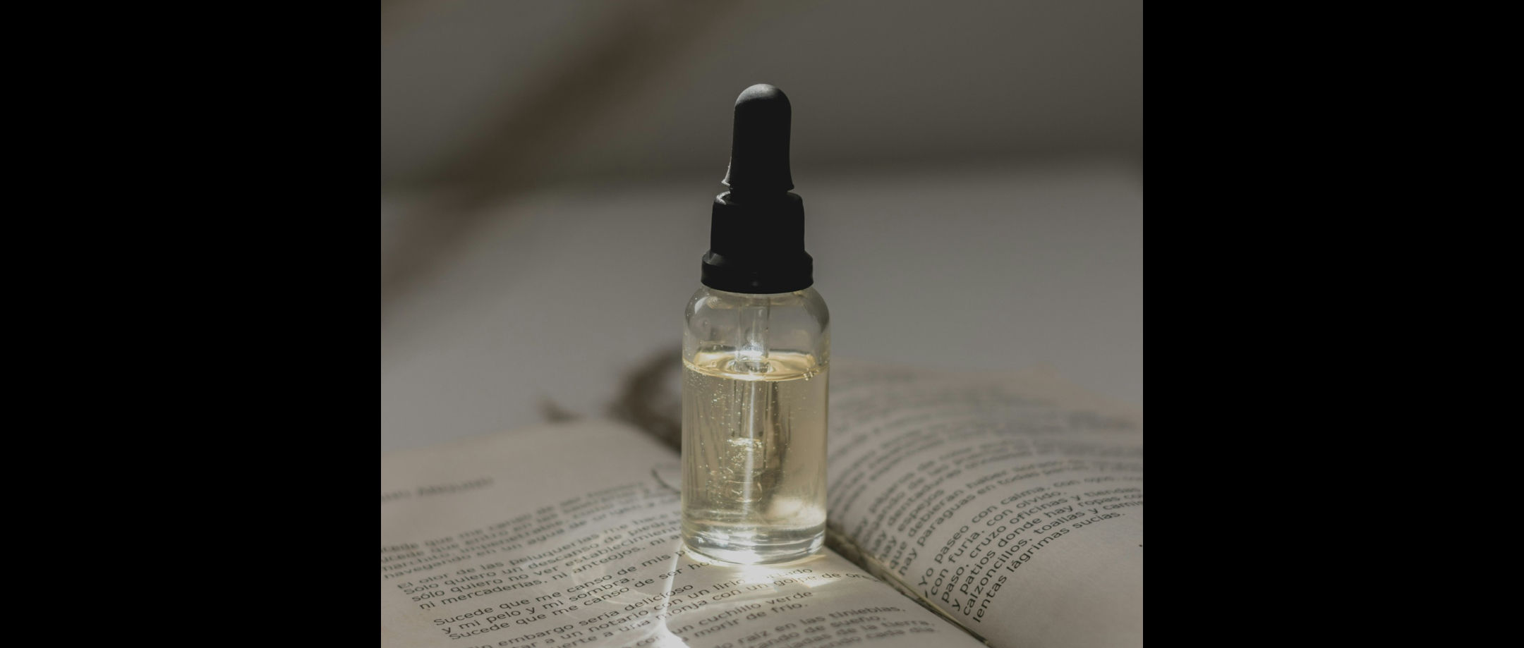 Picture of a vial of oil on a book